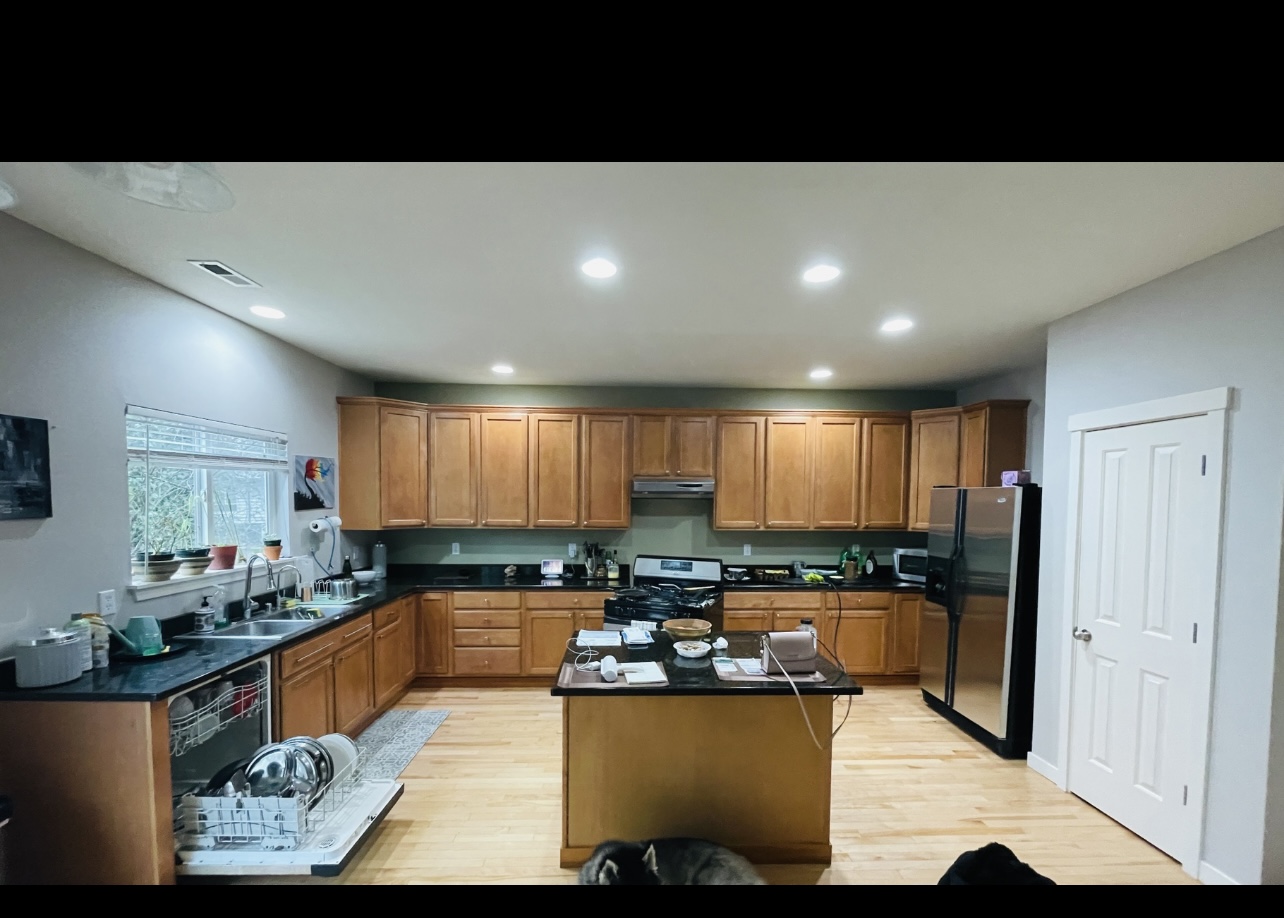 Kitchen with wood cabinets before painting